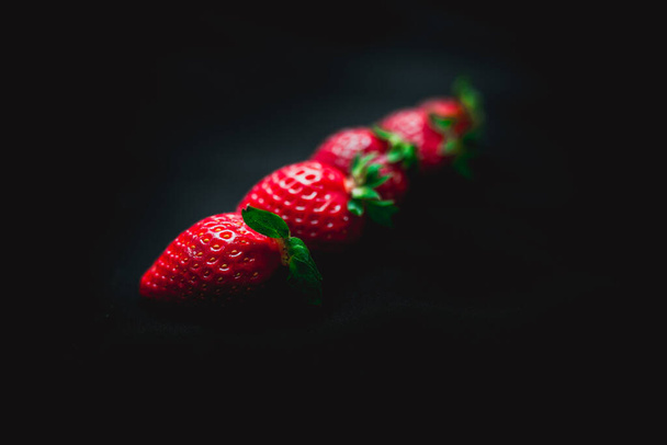 large strawberries on a black background - Foto, Bild