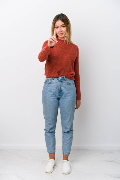 Full body young caucasian woman showing number one with finger. - Valokuva, kuva