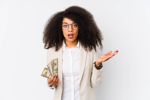 Young afro business woman holding a credit car isolated Young afro business woman holding a credit carsurprised and shocked. - Photo, Image