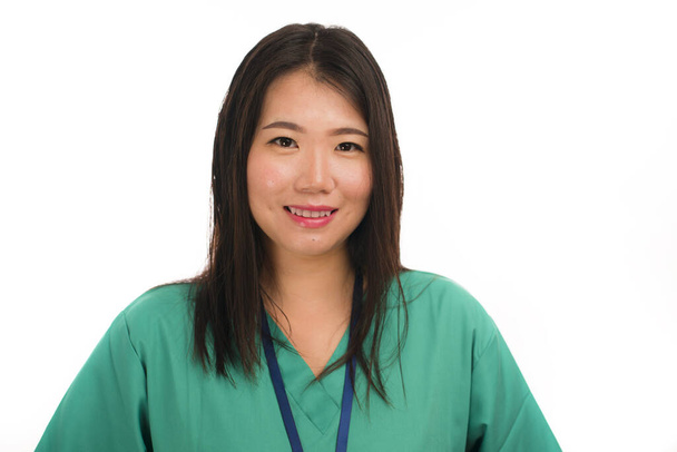 young beautiful and happy Asian Chinese medicine doctor woman or hospital nurse in green scrubs posing cheerful smiling confident in corporate clinic staff portrait  - Foto, Imagem