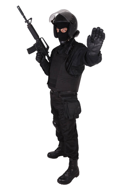 Riot police officer in black uniform with assault rifle - Photo, Image