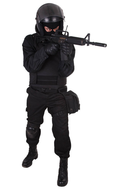 Zavargó rendőr fekete egyenruhában, géppuskával. - Fotó, kép