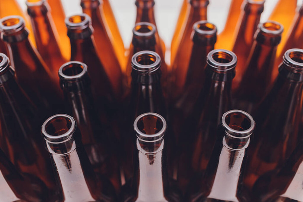 Close-up of beer bottles, focus on middle one, isolated on white background. - 写真・画像