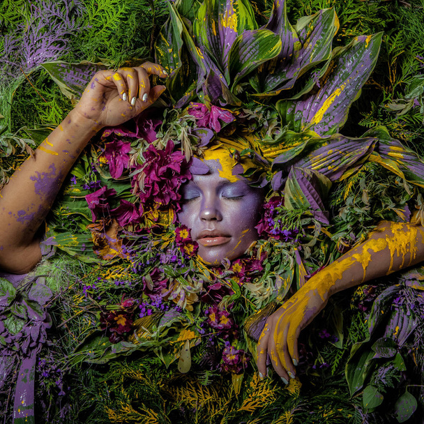 Female portrait in fairy tale stylisation surrounded with natural plants and flowers. - Foto, imagen