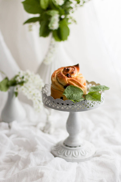 Easter composition with orthodox sweet bread, kulich and spring flowers on light background. - Fotó, kép