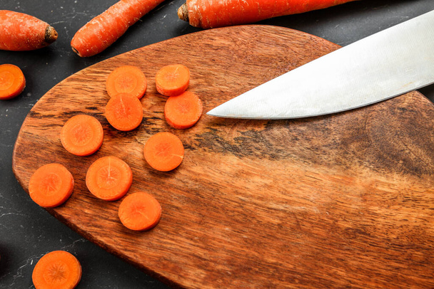 Wooden cutting board (space for text) with carrot sliced to smal - Fotoğraf, Görsel