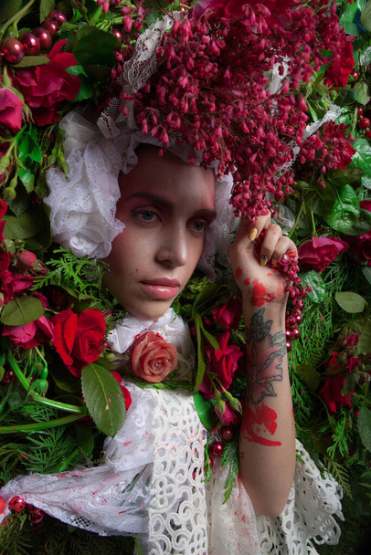Female portrait in fairy tale stylization surrounded with natural flowers. - Foto, Imagen