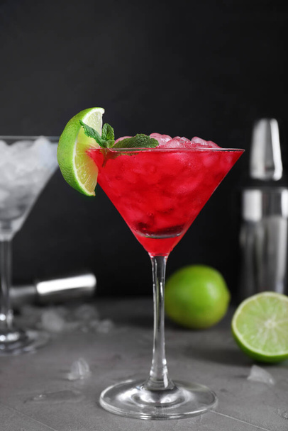 Tasty red alcoholic cocktail in martini glass on light grey table - Φωτογραφία, εικόνα