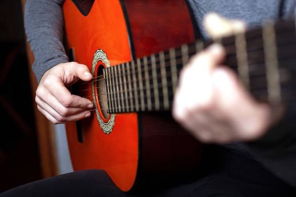 girl playing an acoustic guitar. string musical instrument guitar - 写真・画像