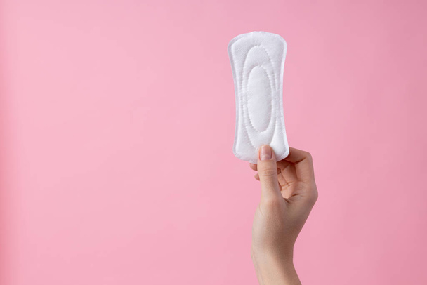 Hand of woman holding menstrual pad stock photo - Φωτογραφία, εικόνα