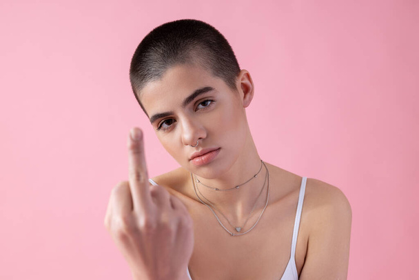 Tired rude young girl showing offensive gesture stock photo - Photo, image