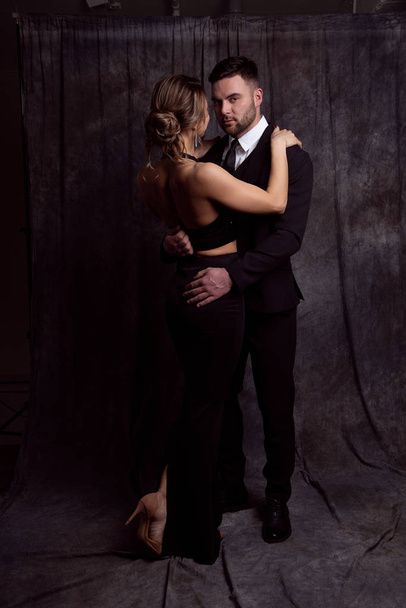 Elegant man and woman tenderly embrace each other - Φωτογραφία, εικόνα