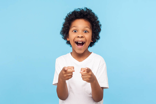 Hey you! Portrait of happy little boy with curly hair pointing f - Фото, зображення