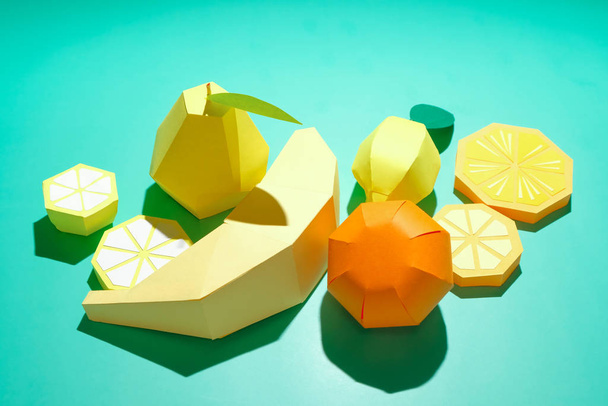 Different exotic fruits made of paper on trendy mint background - Foto, imagen