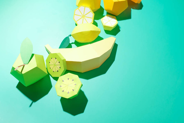 Different exotic fruits made of paper on trendy mint background - Photo, Image