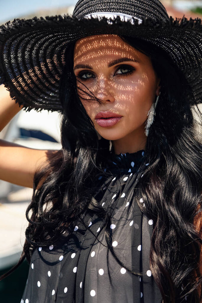 beautiful woman with dark hair in elegant dress and hat - Photo, Image