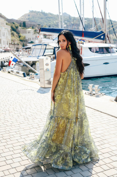 beautiful woman with dark hair in elegant dress posing near luxu - Valokuva, kuva