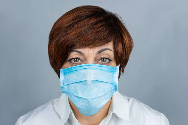 Een vrouw met een medisch masker. Bescherming tegen virussen, ziekten. Virussen. - Foto, afbeelding