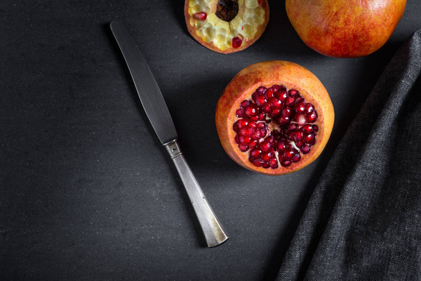 Sliced pomegranate with juicy red grains  - Photo, image