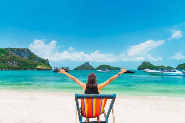 Happy woman traveler relaxing on beach chair joy fun beautiful n - 写真・画像