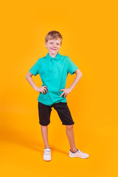 Full length portrait of cute little boy in stylish clothes looking at camera and smiling - Zdjęcie, obraz
