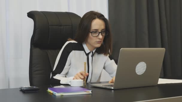 Woman waiting for answer of job promotion, checking her email box on laptop in office. Young female employee worried about mistakes on her job. Businesswoman looking on laptop screen and nervous - Imágenes, Vídeo