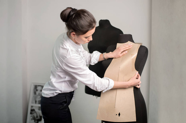 seamstress designer applies pattern at mannequin - Foto, Imagem