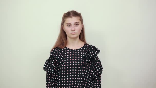 girl in dress with white circles irritably crossed her hands and looks nervously - Footage, Video