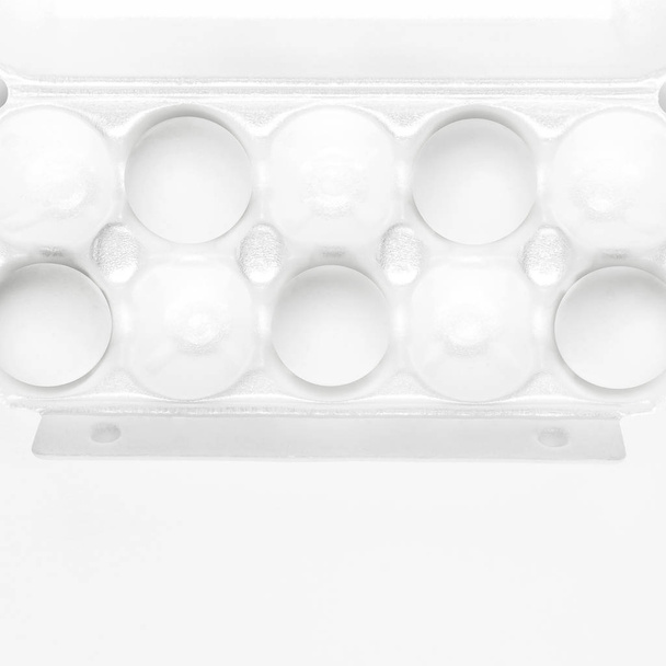 White chicken eggs in white packaging on light background top view flat lay copy space. Eggs in box, natural healthy food and organic farming concept. Creative food minimalistic background, Easter - Φωτογραφία, εικόνα