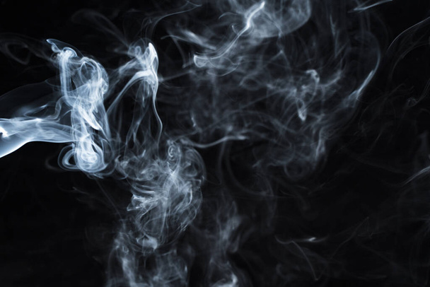 Photo of a wisp of smoke on a dark background - Fotó, kép