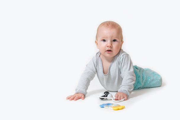 Cute little baby boy is holding toy on the white background - Zdjęcie, obraz