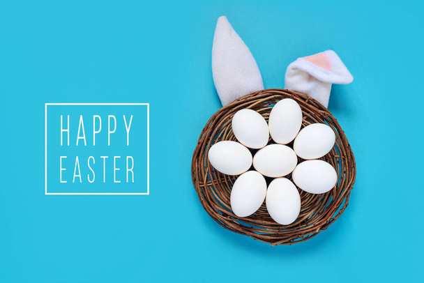Flat lay composition of creative Easter bunny ears on blue background, space for text - Photo, Image