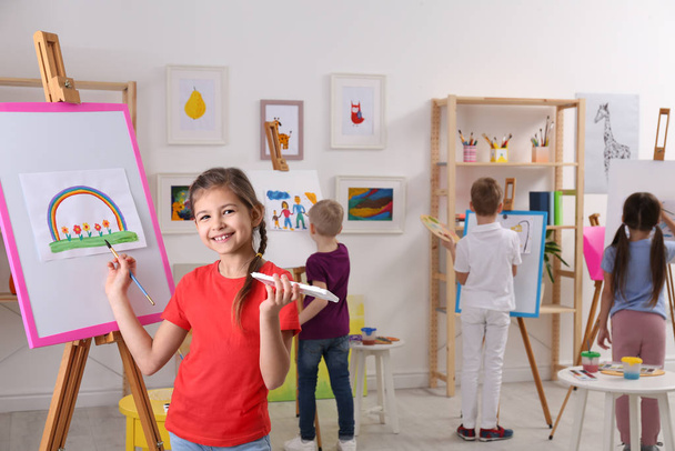 Cute little child painting during lesson in room - Foto, Imagem