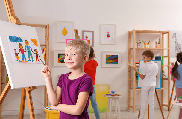 Cute little child painting during lesson in room - Foto, immagini