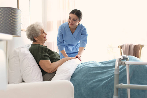 Care worker with elderly woman in geriatric hospice - Foto, Imagen