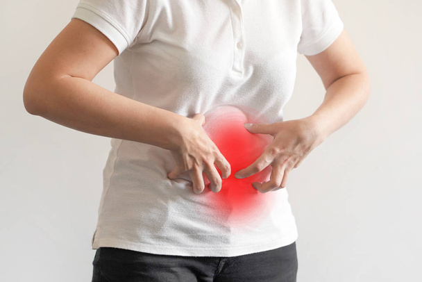 Bellyache, indigestion or menstruation. Female suffering from strong stomach ache abdominal pain. - Photo, Image