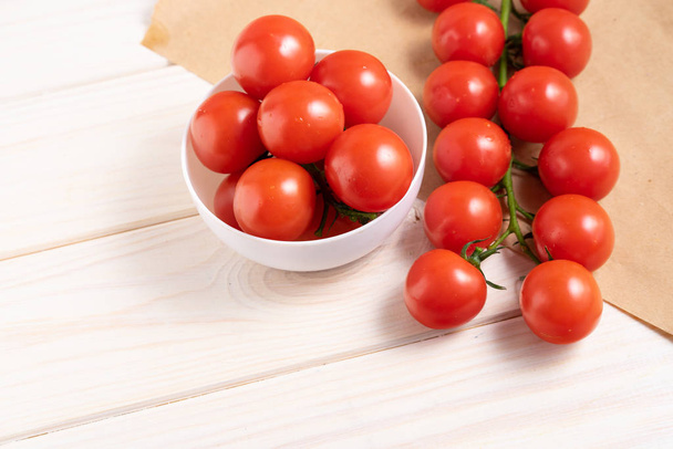 Cherry tomatoes on the white wooden table - Fotografie, Obrázek