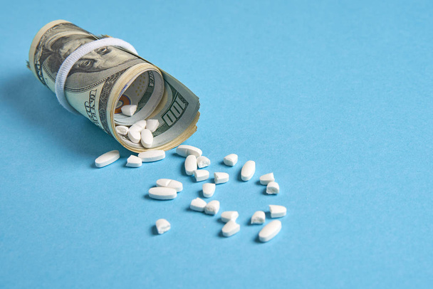 pills empty blisters for drugs individual syringe and money lie on a blue background - Photo, image