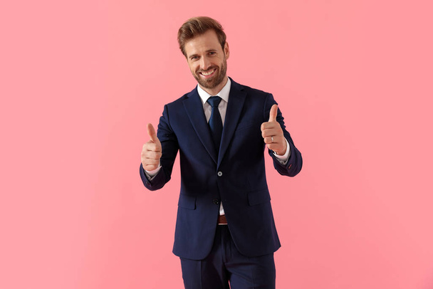 Confident businessman giving a double thumbs up and laughing - Photo, Image