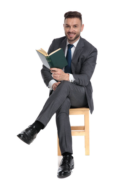 happy young man holding book and smiling - Photo, image