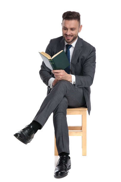happy young businessman reading and smiling - Foto, Imagem