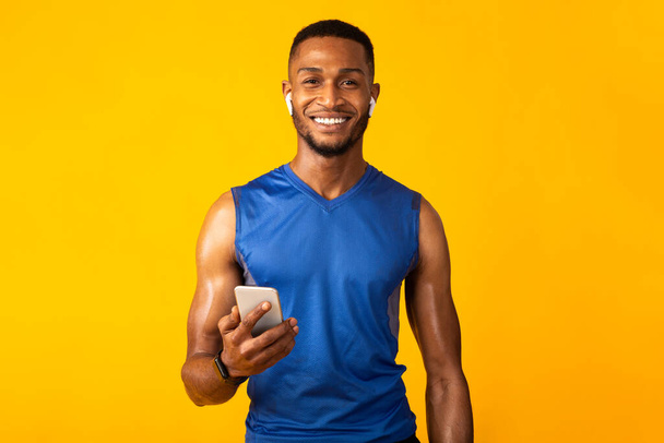Portrait of handsome athletic black man with headphone - Фото, изображение