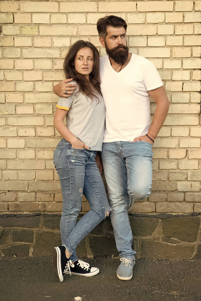 Family day. Careful hug of loving people. Just hang out together. Couple in love. Family couple hugging on brick wall background. Bearded man and sexy woman cuddling. Sensual couple together - Photo, Image
