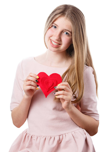 girl with red heart in hands on white background. - Photo, Image