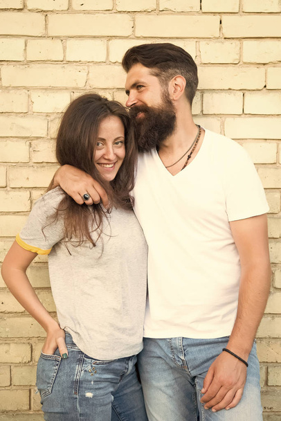 Just hang out together. Couple in love. Family couple hugging on brick wall background. Bearded man and sexy woman cuddling. Sensual couple together. Family day. Careful hug of loving people - Фото, зображення