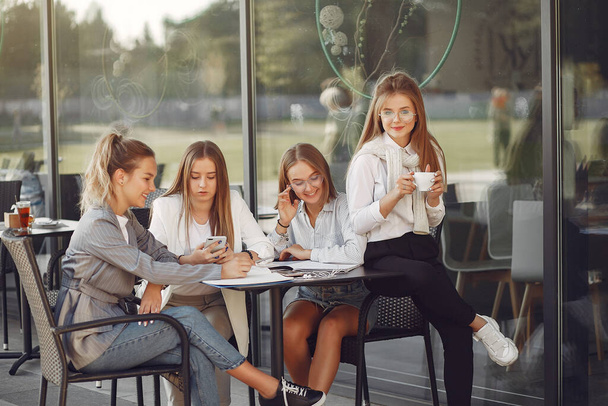 Four students on a student campus sitting at the table - Фото, зображення