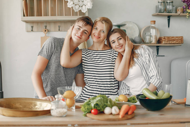 Beautiful big family prepare food in a kitchen - Photo, image