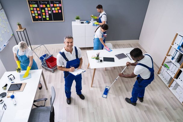 Janitor With His Team Cleaning Modern Office - Foto, imagen