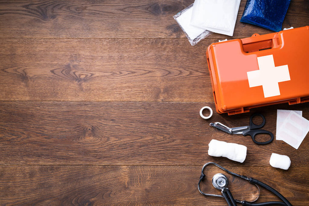 First Aid Kit With Medical Equipment On Wooden Background - 写真・画像