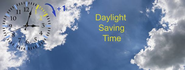 Daylight Saving Time (DST). Blue sky with white clouds and clock. Turn time forward (+1h). - Photo, Image